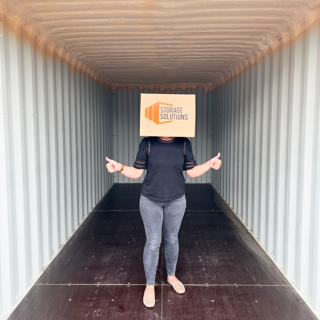 a person standing inside of an open shipping container