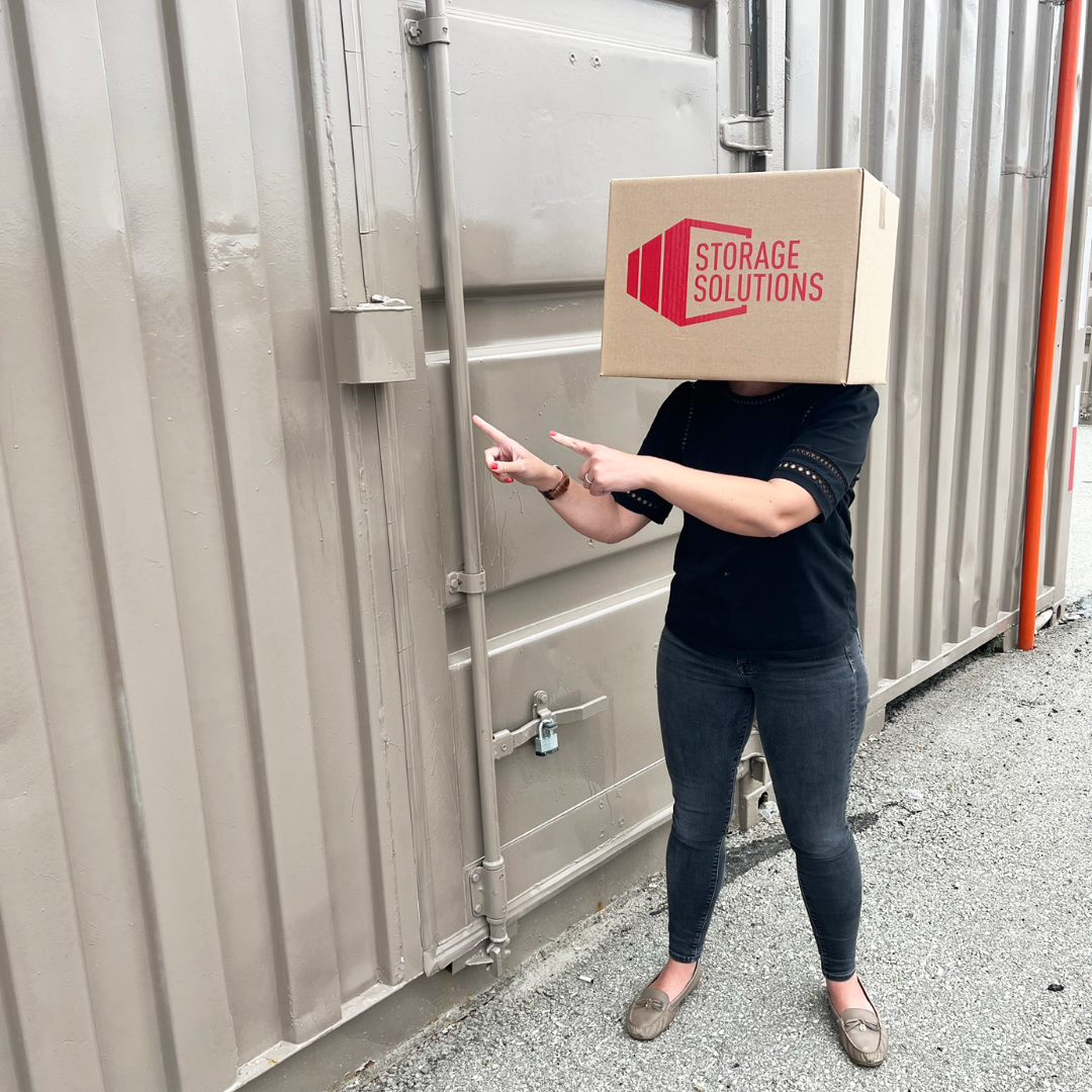 a person pointing to the steel lock box on a shipping container door